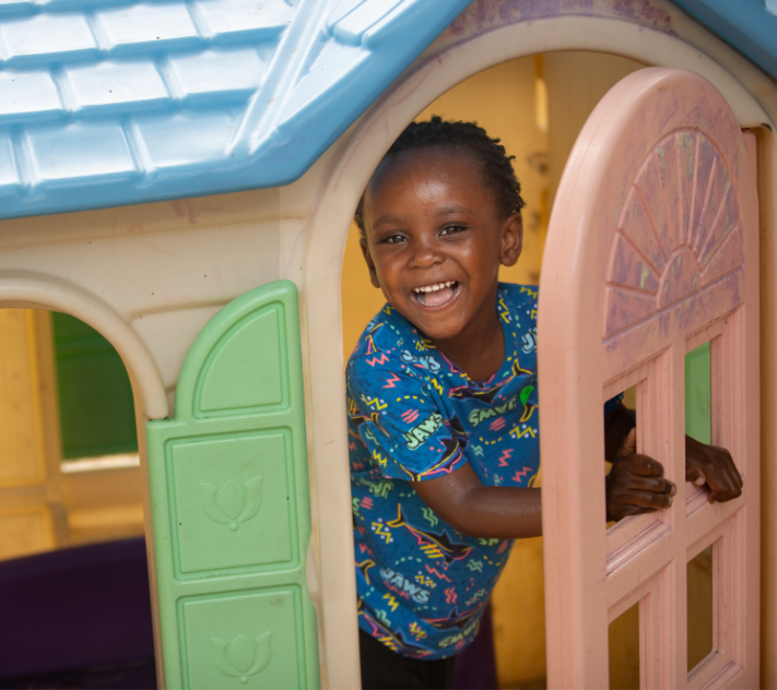 Young boy in a toy play house