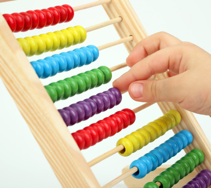 children's counting toy with child's hand moving counters