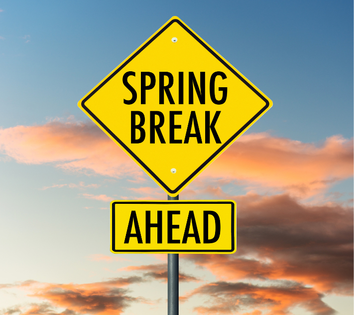 Road sign that says "spring break ahead" with clouds behind it